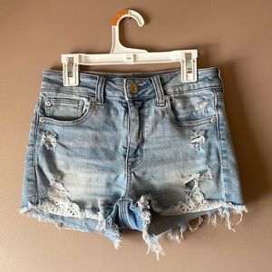 American Eagle high waisted distressed jean shirts with detailed pockets, size 2